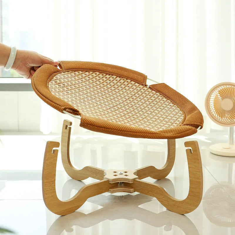 Brown woven rattan pet hammock bed for cats and small dogs on a flat surface.