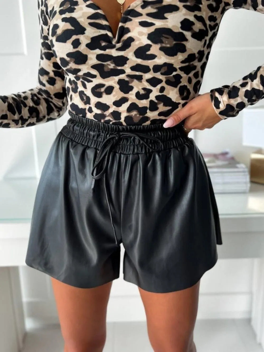 Women's black wide-leg casual shorts with a front drawstring lace detail and PU leather trim.