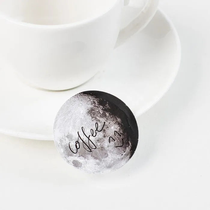 Box containing 45 black moon phases and calendar planet decorative stickers on self-adhesive paper.