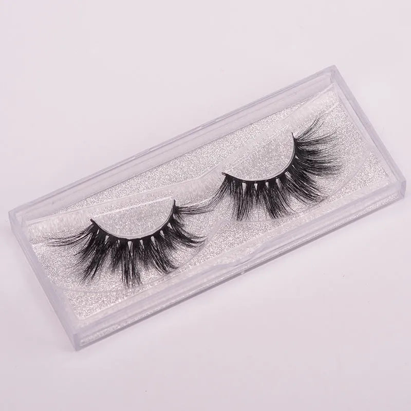 Affectionate brand 5D mink false eyelashes with a hair cap and double-headed brush on a pink background.