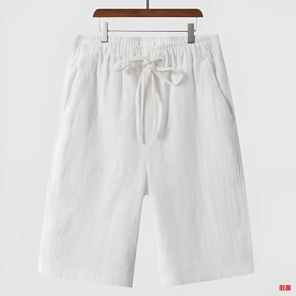 Men's beige linen casual shorts with a loose fit and elastic waistband on a neutral background.