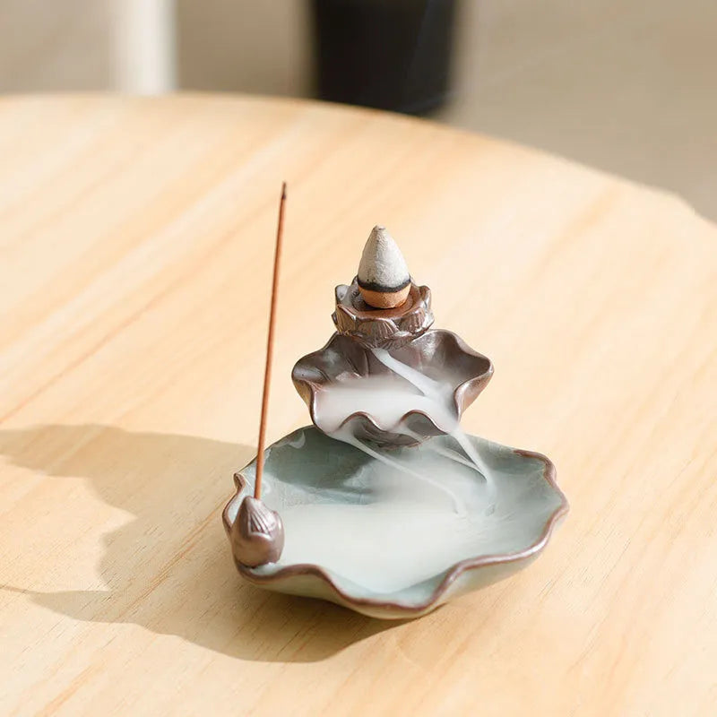 Square ceramic incense burner with reverse flow design showing smoke cascading down sides, Ge kiln crackle glaze patterns visible