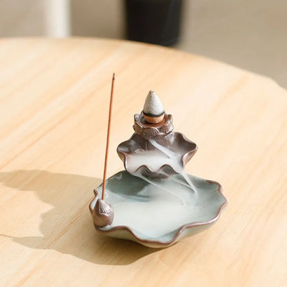 Square ceramic incense burner with reverse flow design showing smoke cascading down sides, Ge kiln crackle glaze patterns visible