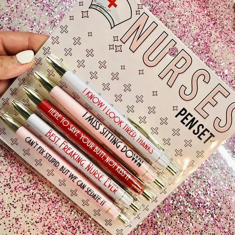 Set of five white plastic retractable ballpoint pens with blue and red nurse-themed text and graphics.