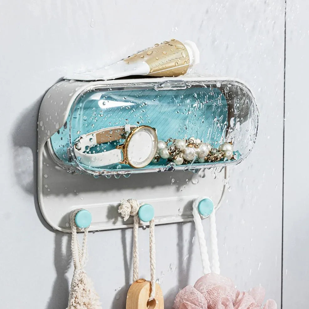 Grey punch-free bathroom storage box mounted on wall with transparent lid showing glasses inside