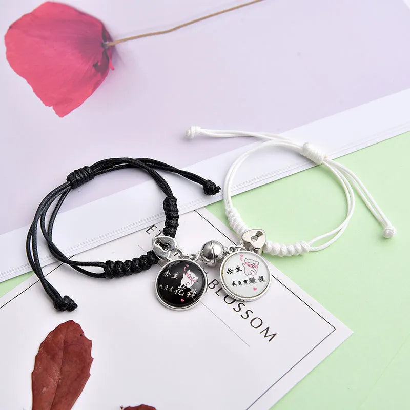 A pair of magnet couple bracelets with a suction clasp, showing various design options like clovers, crowns, and hearts.