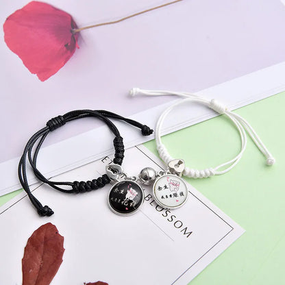 A pair of magnet couple bracelets with a suction clasp, showing various design options like clovers, crowns, and hearts.