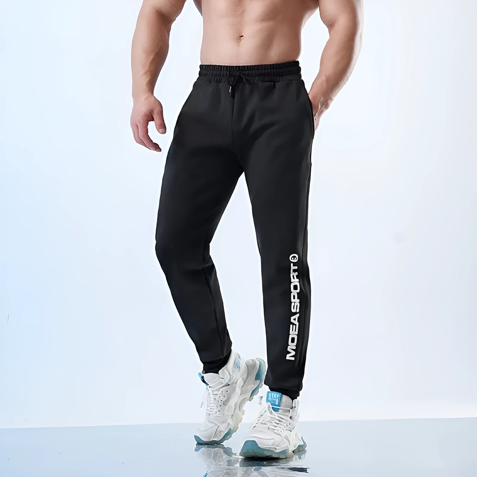 Men's black ankle-tied sweatpants with mid waist and adjustable ankle tie on hanger
