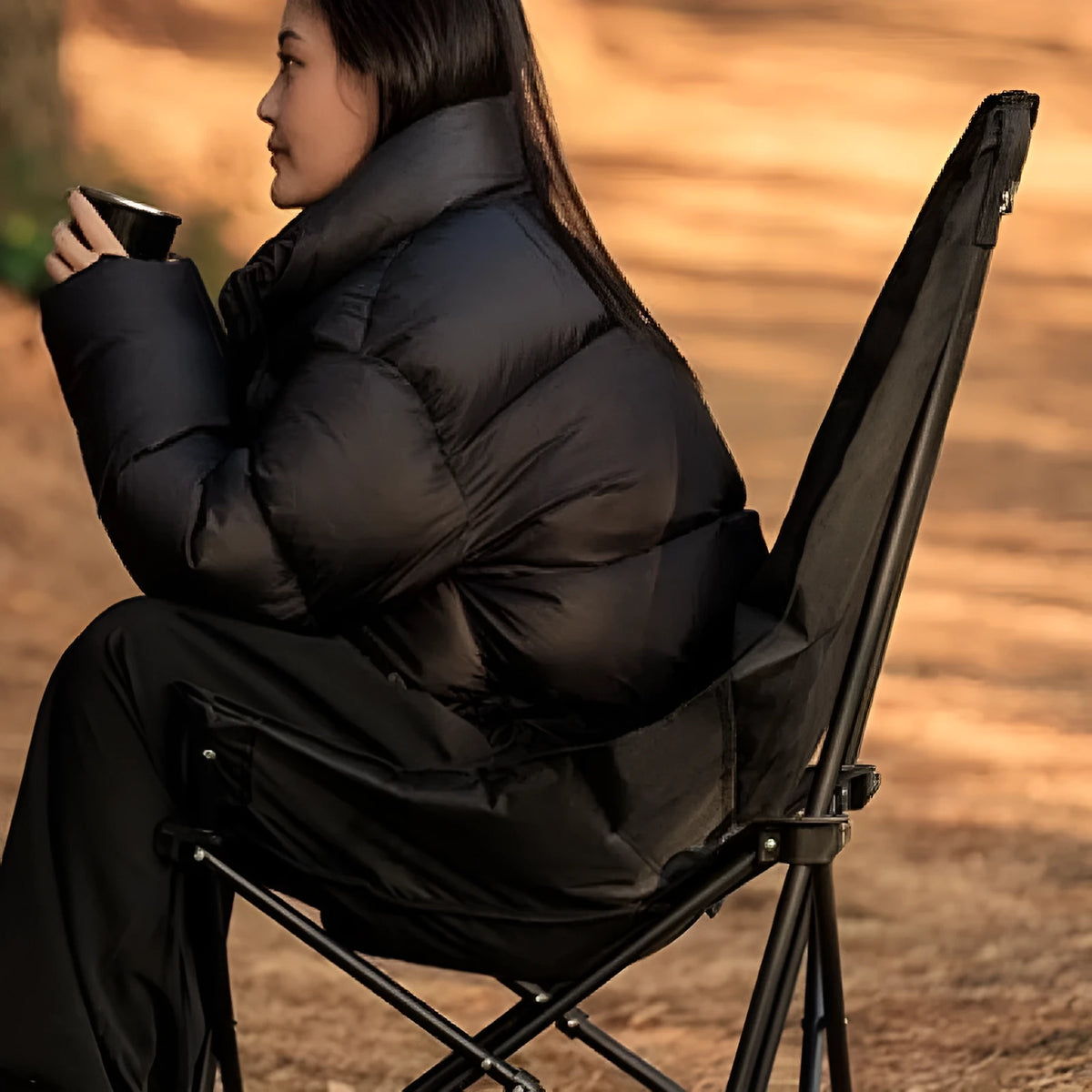 Night black folding camping recliner with Oxford cloth seat and moon chair style, shown in an outdoor setting.