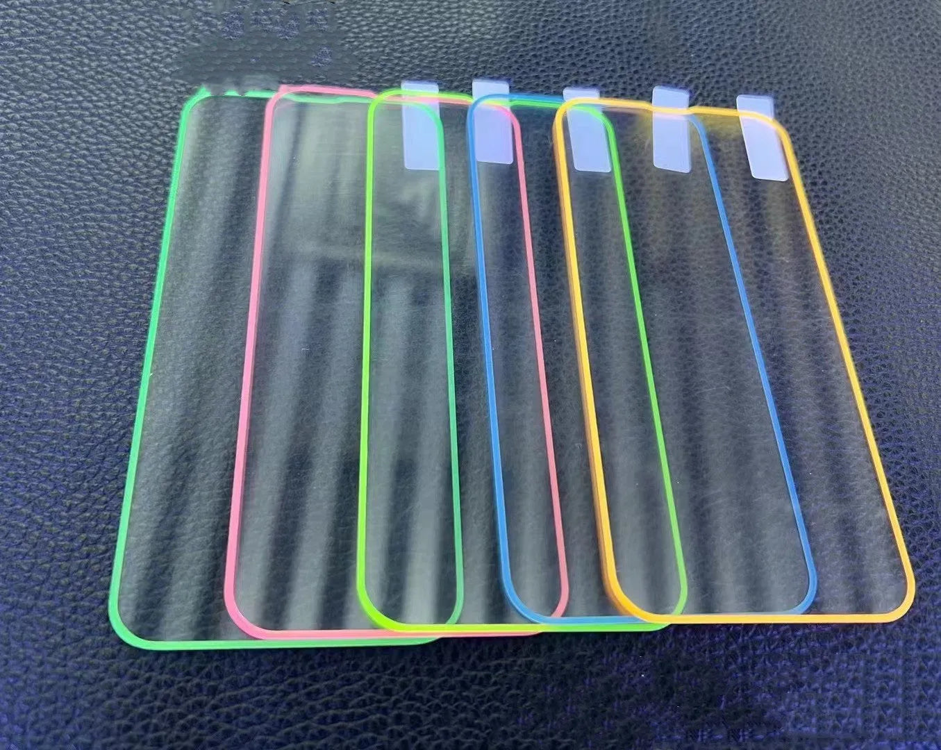 Fluorescent tempered glass screen protector for iPhone with luminous glow in pink, yellow, green, blue, and grass green colours