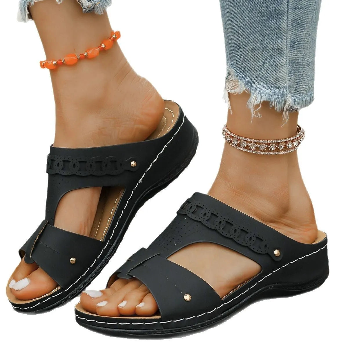 Beige Roman style slippers with a fish mouth toe, slope heel, and rubber sole.