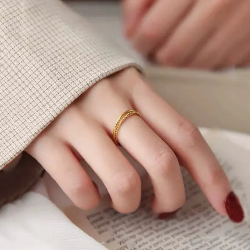 Gold-plated brass women's ring showing twist and simple bracelet styles in matte and glossy finishes.