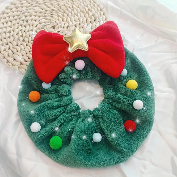 Red bow-knot Christmas pet scarf with colourful fuzzy balls on a dog, showing floral pattern and adjustable fit.
