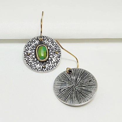 A pair of retro-style earrings with turquoise colour separation and an antique silver electroplated finish.