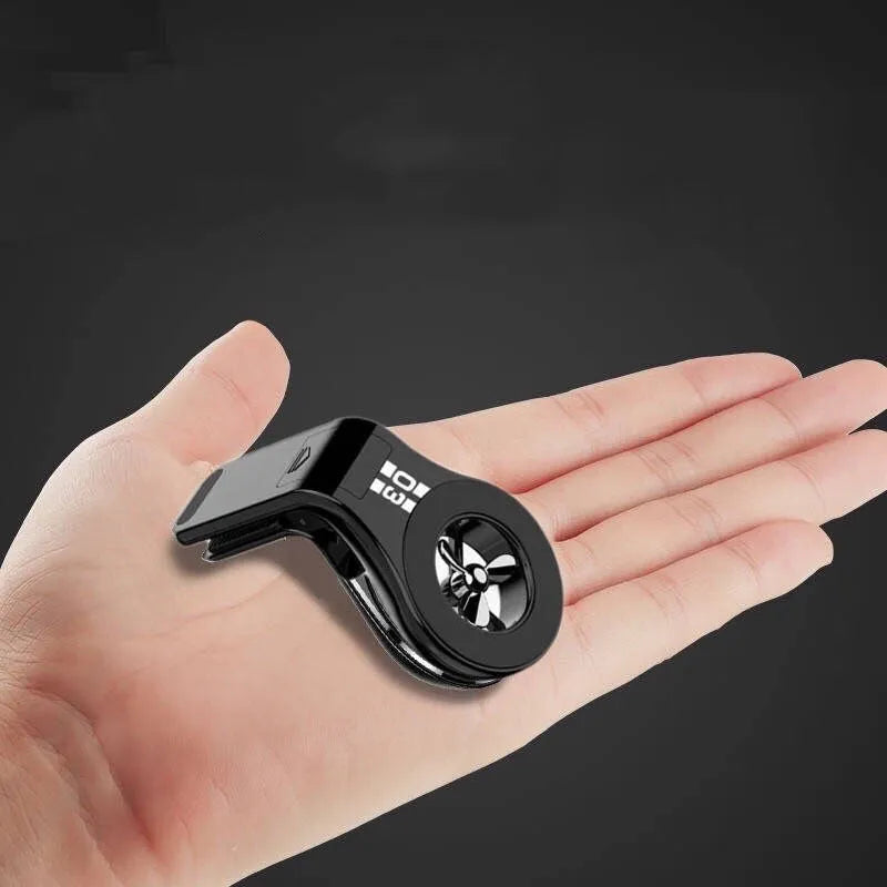 Black magnetic car phone holder attached to air vent with phone mounted and fragrance slice visible