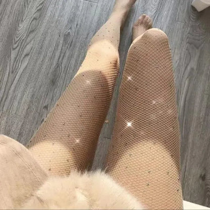 A pair of women's sheer black fishnet ankle socks with a diamond mesh pattern and soft acrylic cuff, laid flat.
