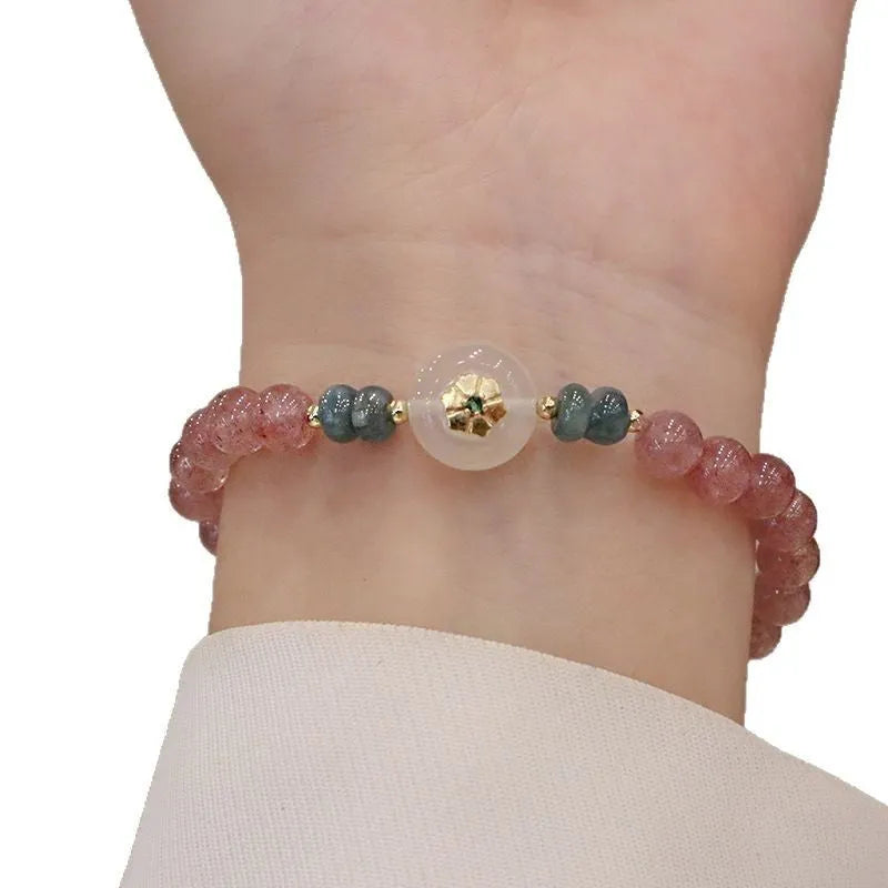 Women's bracelet with strawberry quartz stones and blue water emerald round jade pendant featuring peace buckle closure