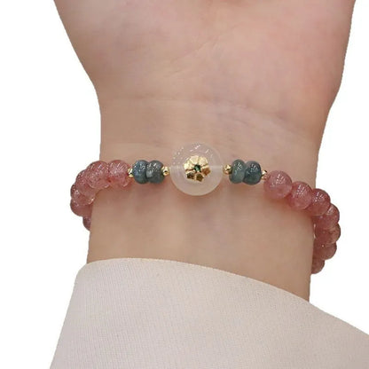 Women's bracelet with strawberry quartz stones and blue water emerald round jade pendant featuring peace buckle closure