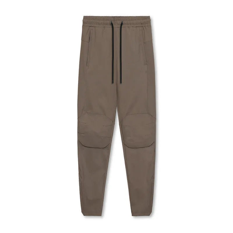 Men's grey fitness trousers with ankle ties, made from 100% polyester for quick-drying during exercise