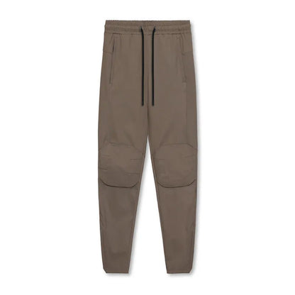 Men's grey fitness trousers with ankle ties, made from 100% polyester for quick-drying during exercise