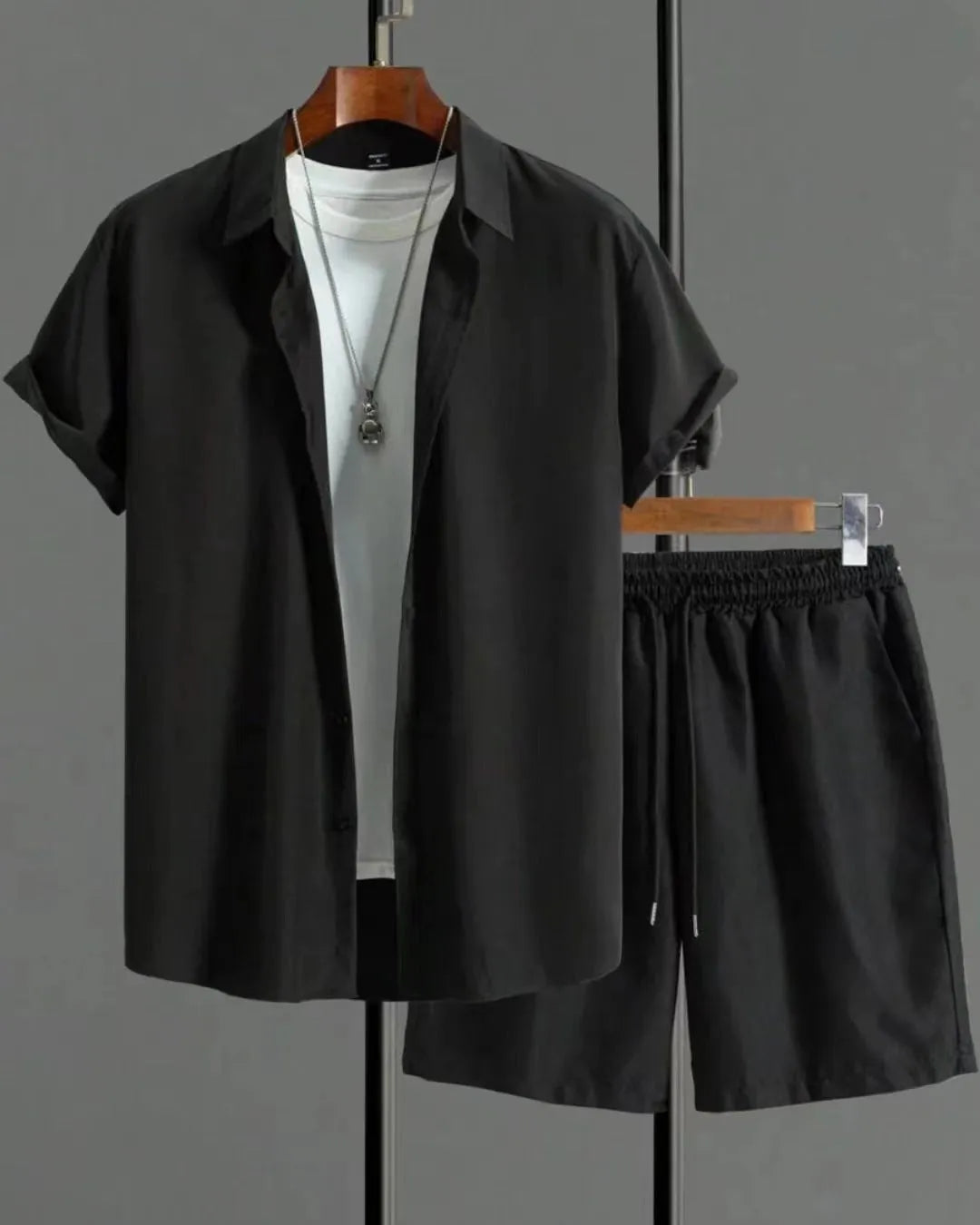 Man wearing a black and white jacquard short sleeve shirt and matching shorts suit set.