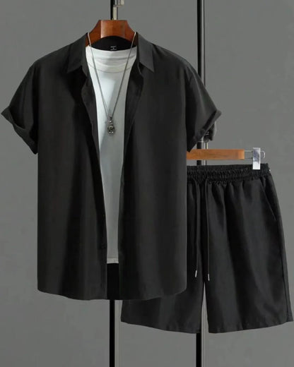 Man wearing a black and white jacquard short sleeve shirt and matching shorts suit set.