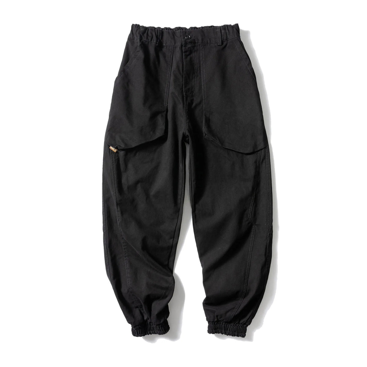Solid colour cotton casual pants with large pockets and a tapered, ankle-tied silhouette.
