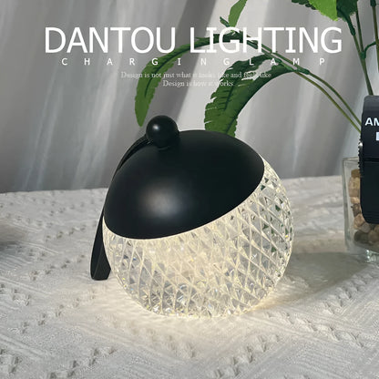 Small portable desk lamp with touch dimmer in gold finish, 12cm tall.