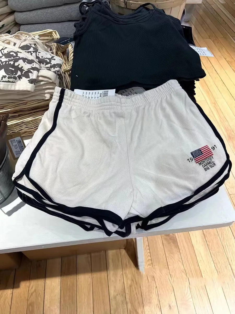 Dark blue cotton sports shorts with navy colour blocks and white flag embroidery for women