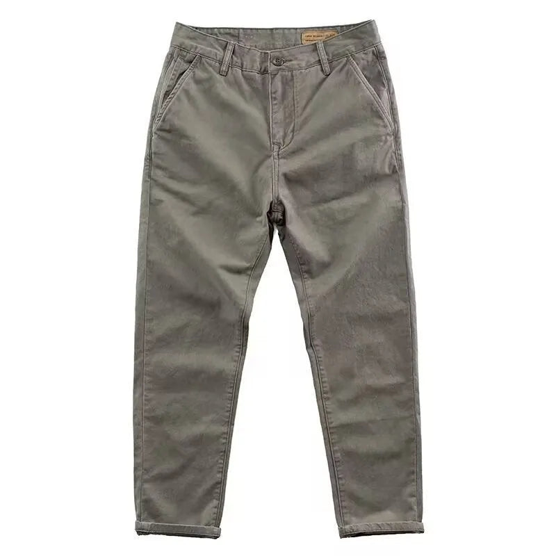 Man wearing slim fit grey micro elastic washed trousers with a straight leg cut for a business casual look.