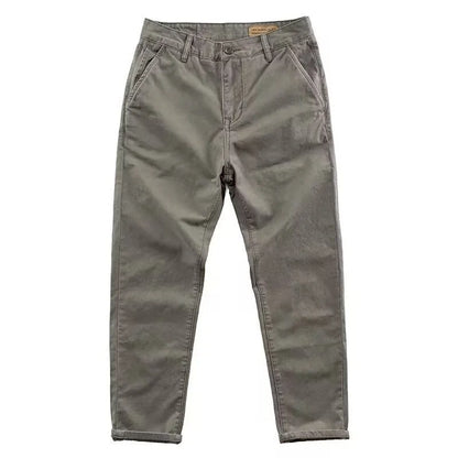 Man wearing slim fit grey micro elastic washed trousers with a straight leg cut for a business casual look.