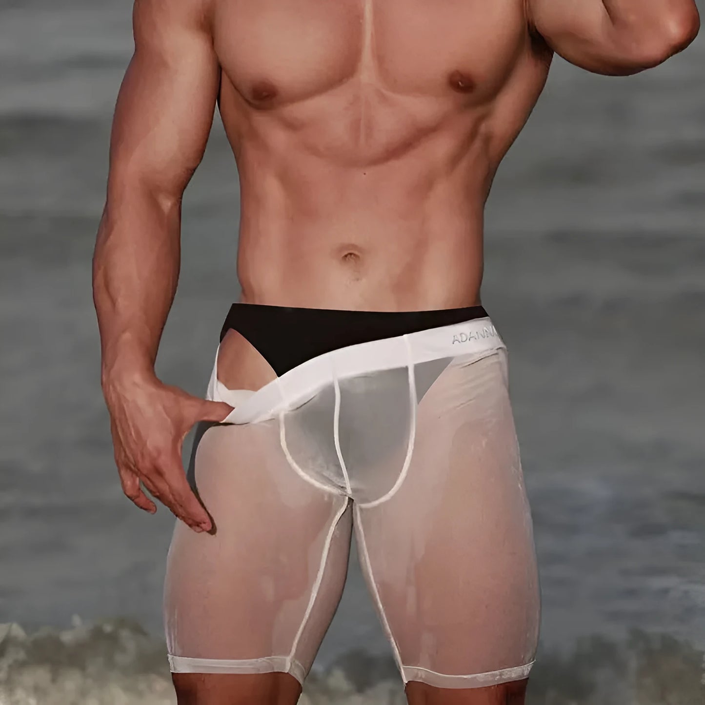 Men's black seamless nylon mesh lounge shorts on a hanger, showing hip-lift design and knitted texture.