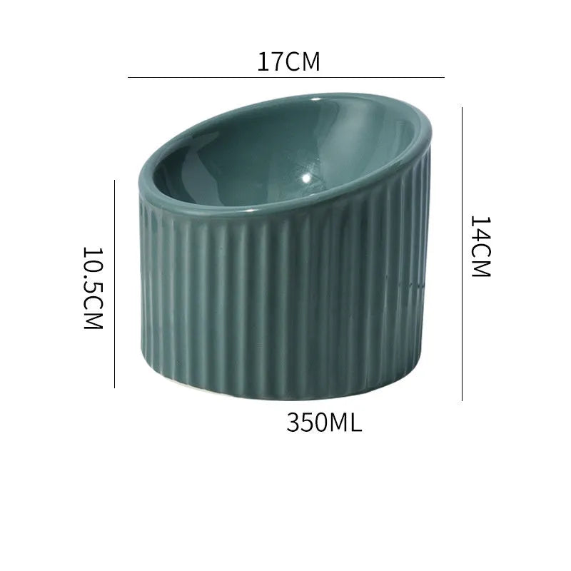 Ceramic elevated cat bowl in green colour showing tilted, round whisker-friendly design.