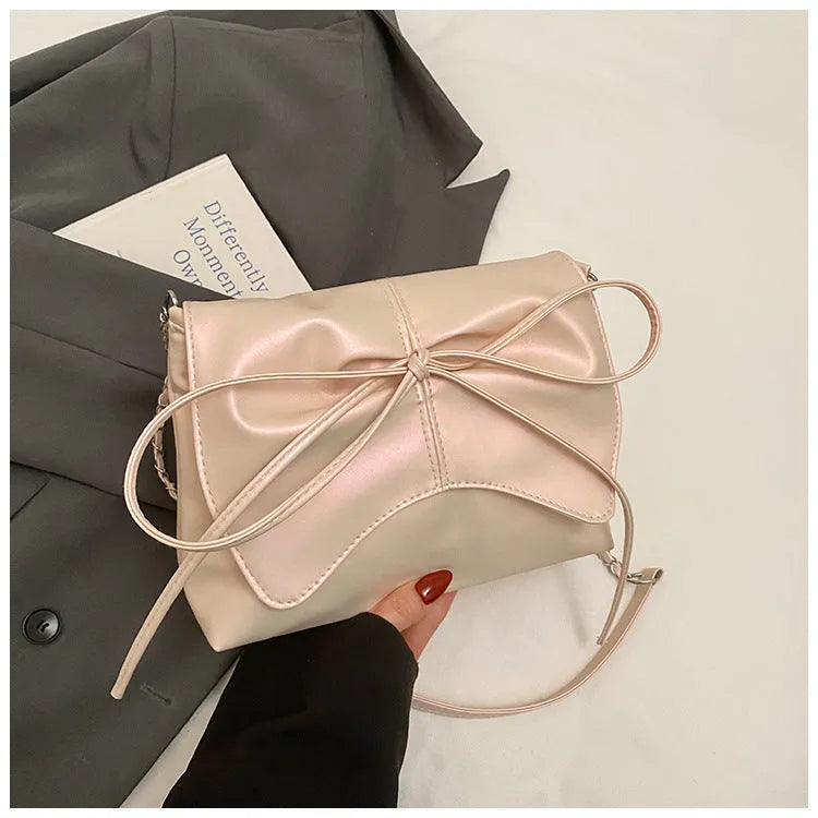 Black horizontal square PU crossbody bag showing internal mobile phone pocket and crossbody strap