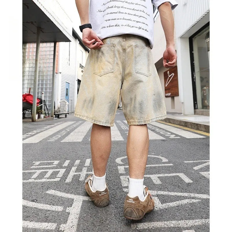 Men's light blue denim shorts with distressed finish and straight-leg silhouette
