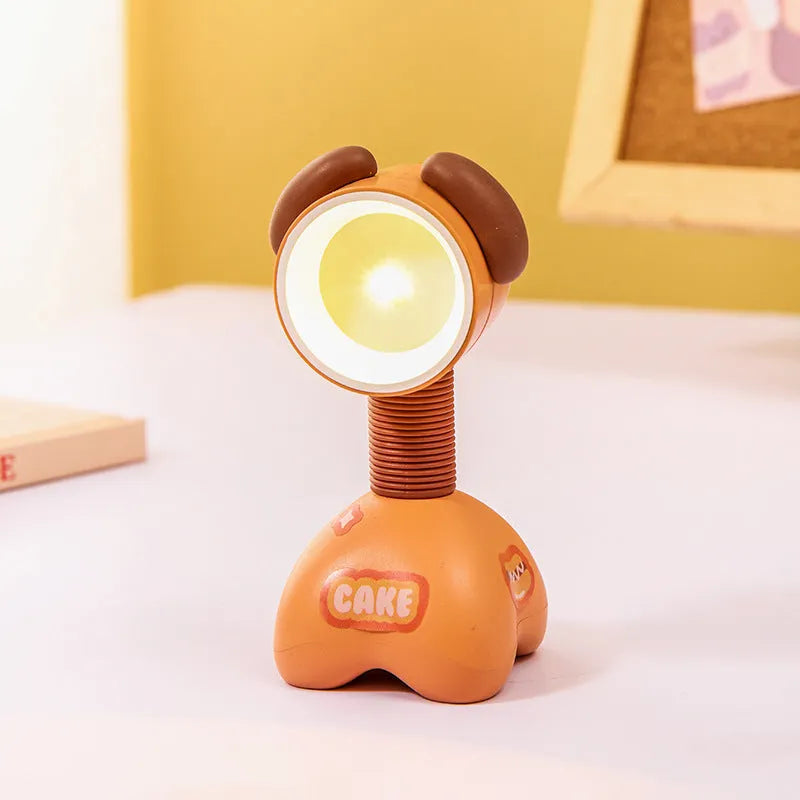 Colourful cartoon character magnetic DIY night light on a desk with adjustable head.