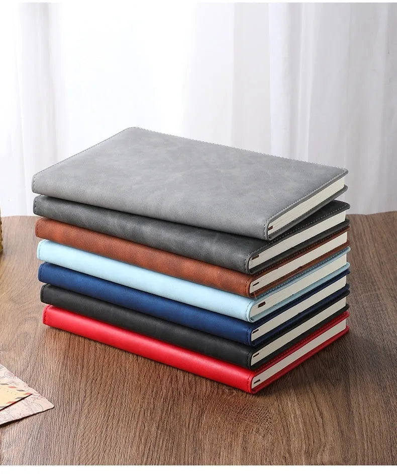 A5 notebook with imitation leather cover in colour options including black, red, green, blue, and orange.