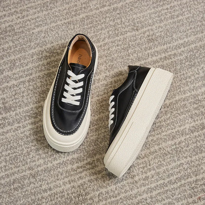 Women's black platform casual shoes with round toe and tied laces on a rubber sole.