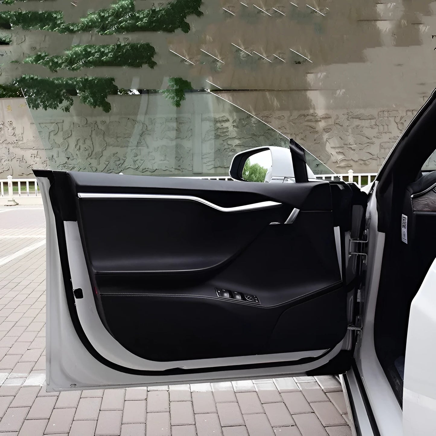 Carbon fibre protective film for Tesla Model S car doors showing four-piece set for front and rear door coverage