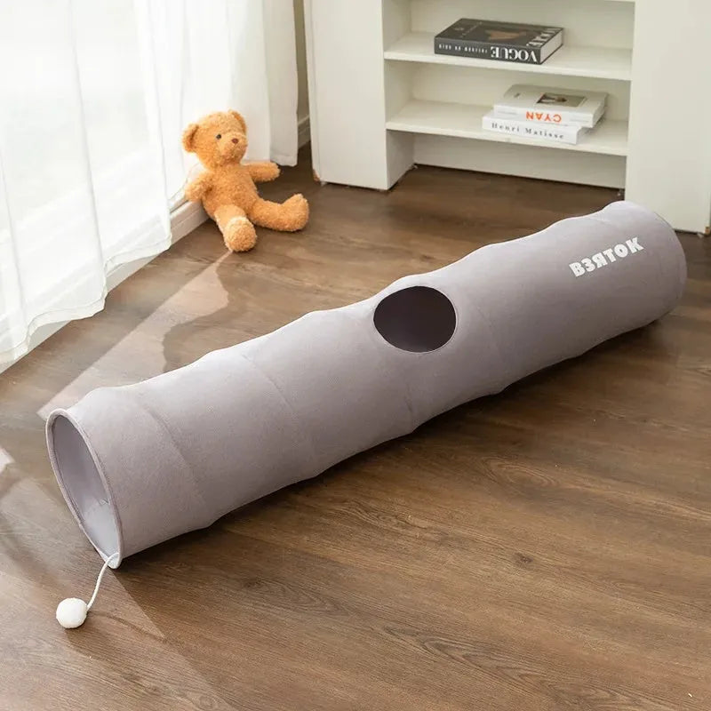 Collapsible cat tunnel in grey with attached plush ball, showing folded and extended positions