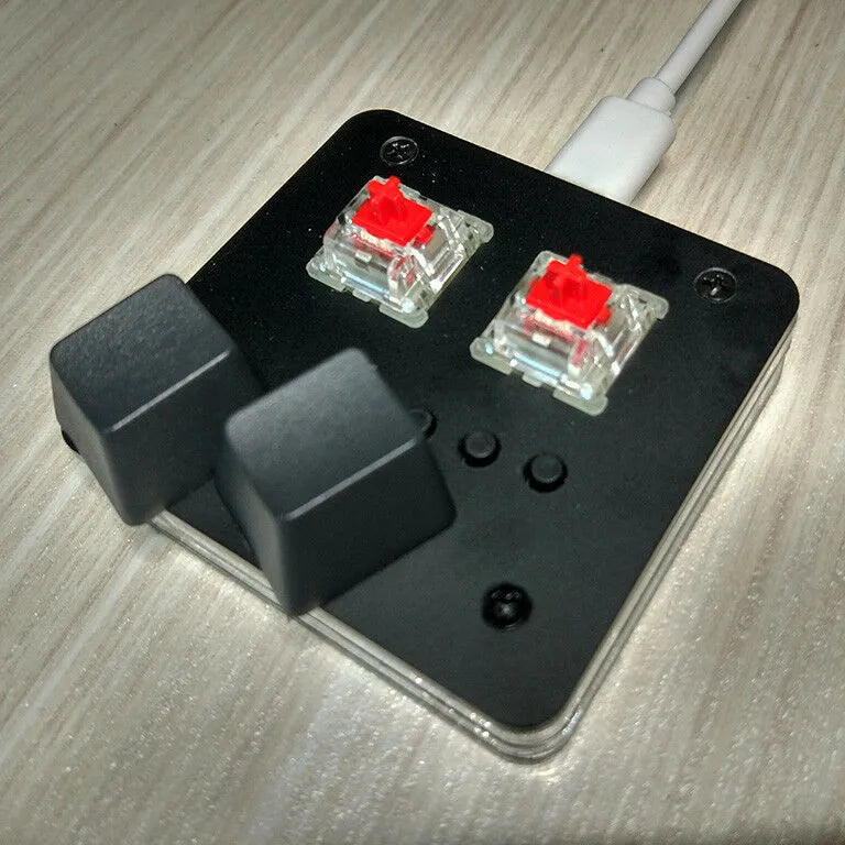 Mini USB wired keyboard in white, light grey, black, or pink colour on a desk.