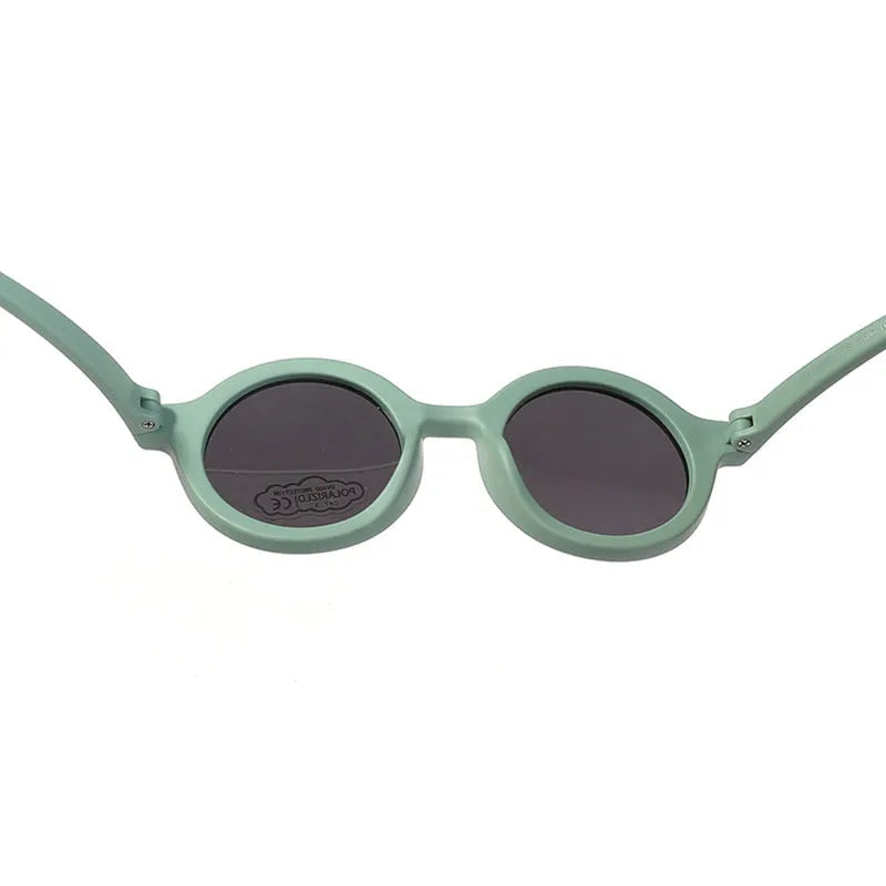 Children's round-frame polarised sunglasses with soft TPEE frame for ages 0-3, shown in assorted colours.