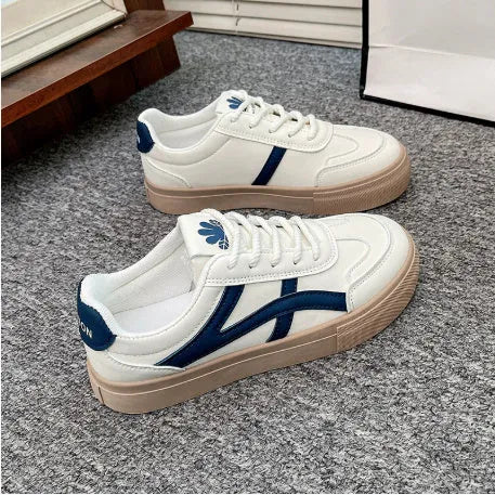 Low-top blue and brown casual lace-up shoes with round toe and flat rubber sole.