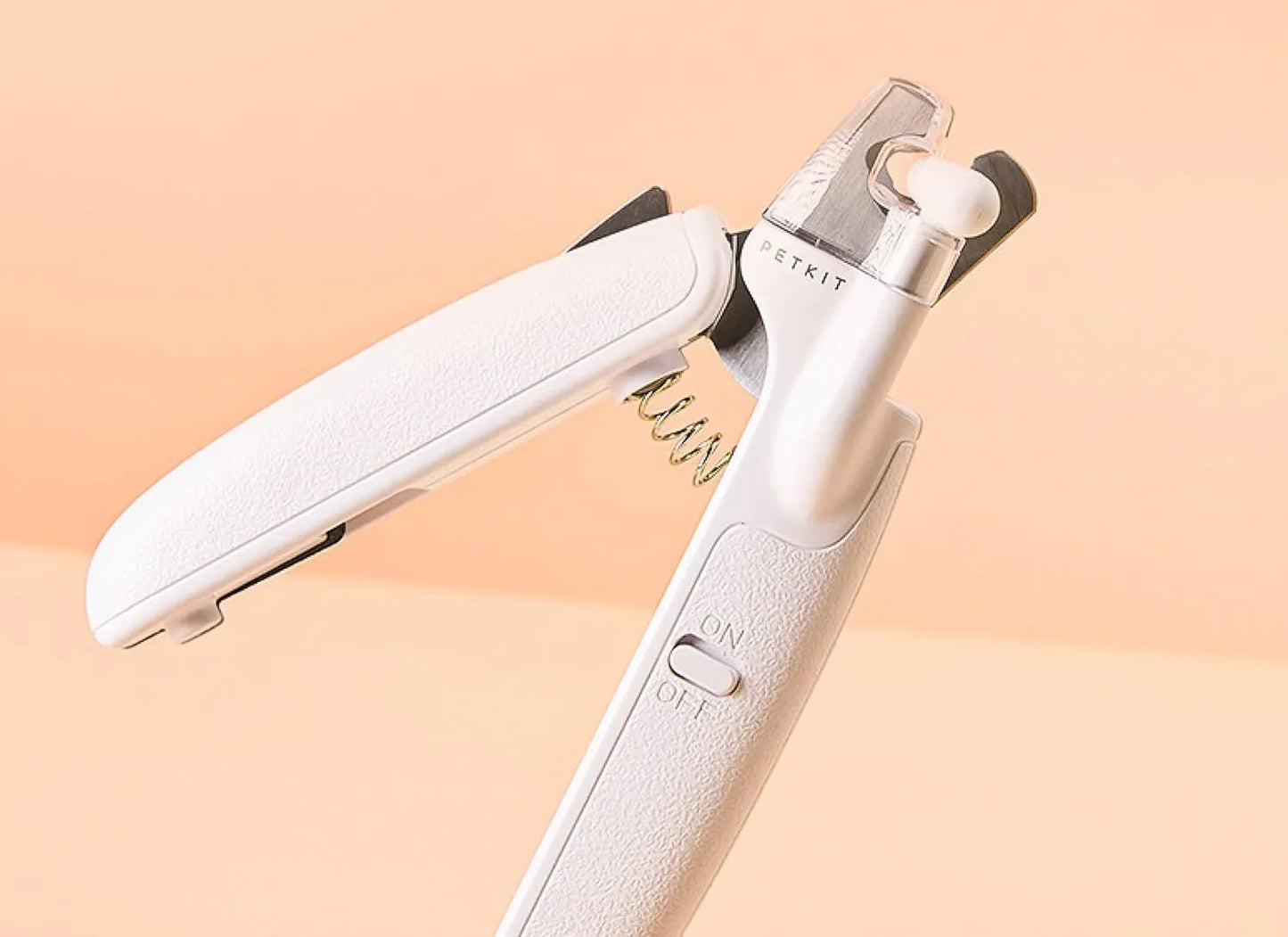 White LED pet nail clippers with a transparent safety guard and a nail file on a grey background.