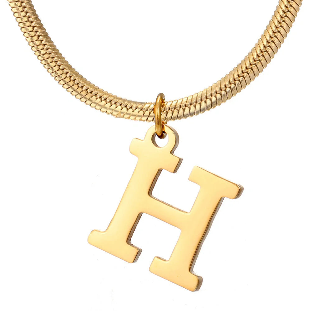 Elegant gold A-Z letter pendant necklace on a snake chain