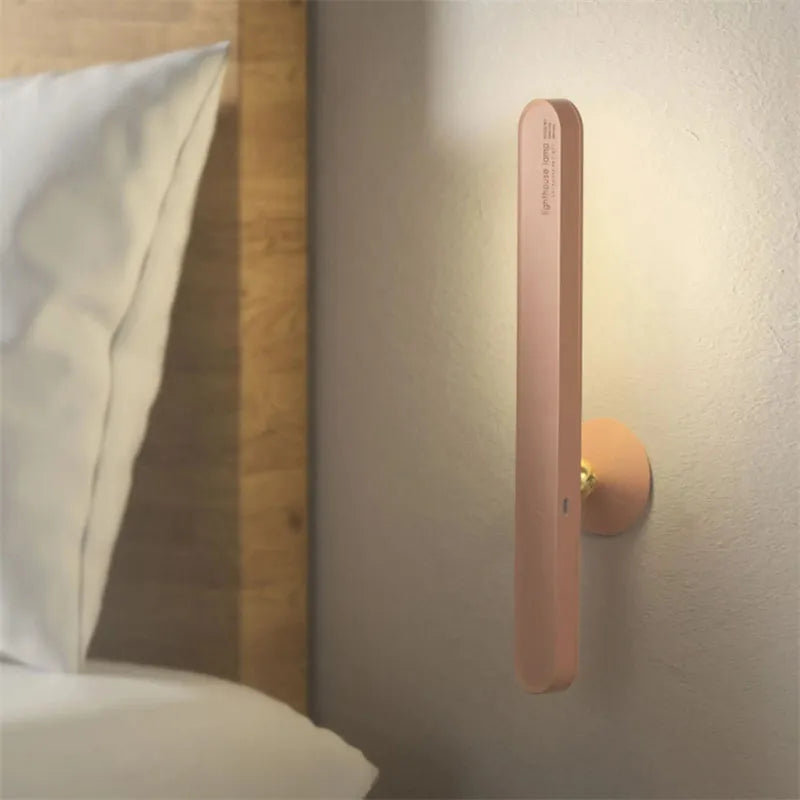 White geometric desk lamp with magnetic base and touch control on a wooden table.