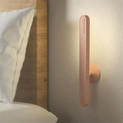 White geometric desk lamp with magnetic base and touch control on a wooden table.