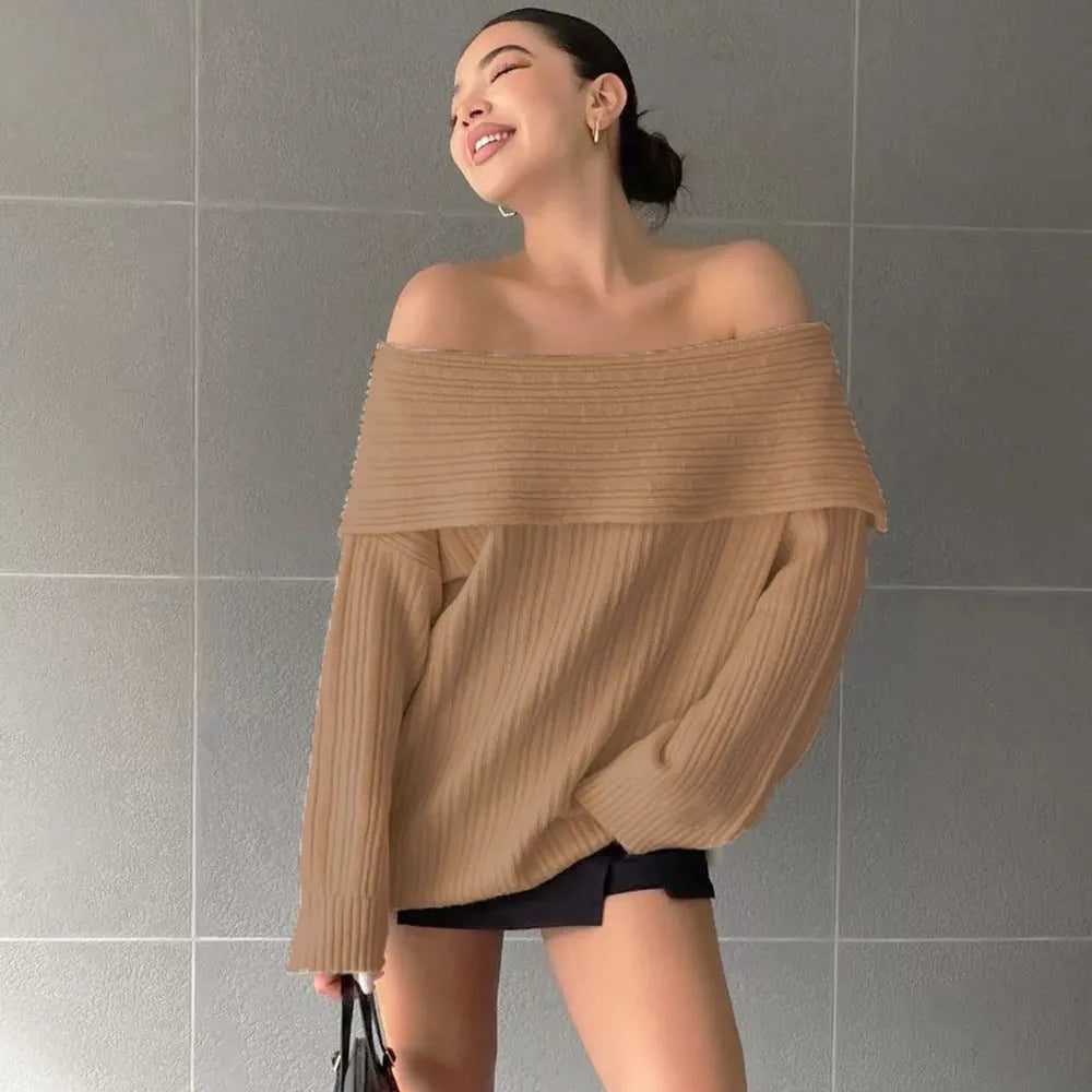 Woman wearing a loose white acrylic knit pullover sweater with long sleeves and an off-neck design.