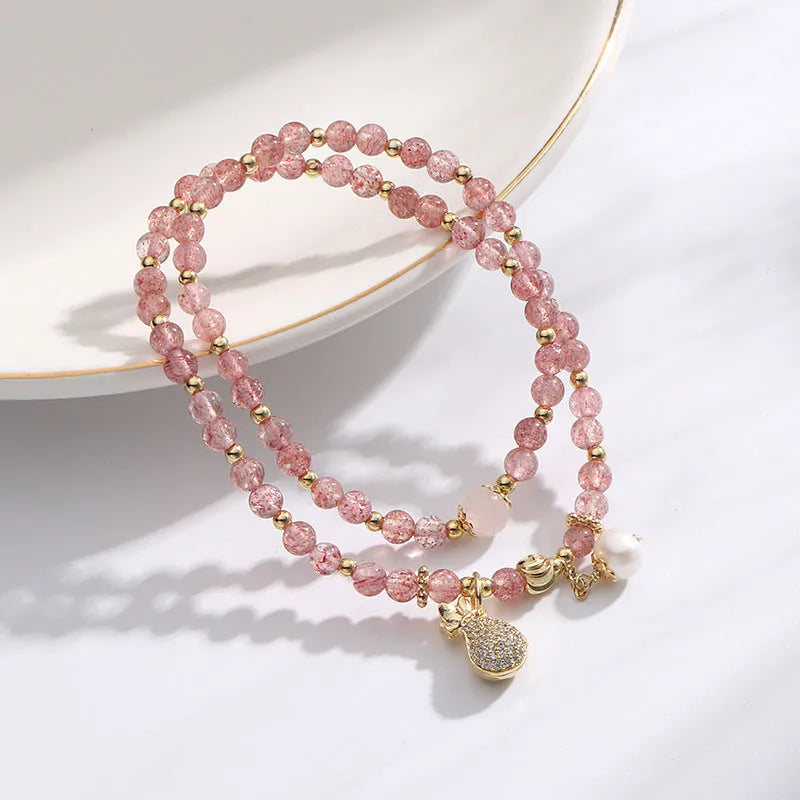 Geometric strawberry quartz crystal bracelet for women on a white background.