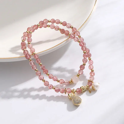 Geometric strawberry quartz crystal bracelet for women on a white background.